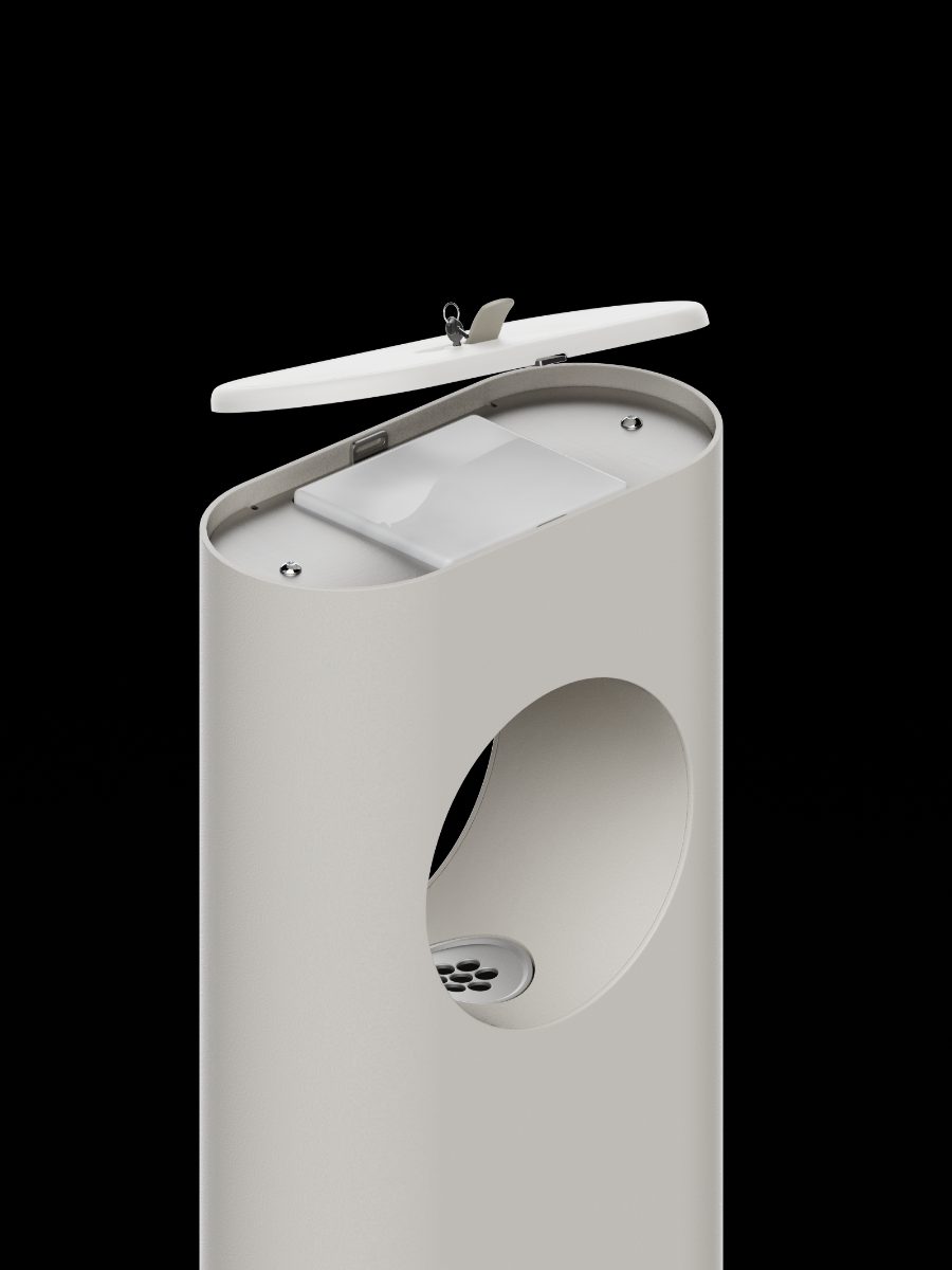 The dispenser with its lid lifted open, showing the cartridge bay inside the top