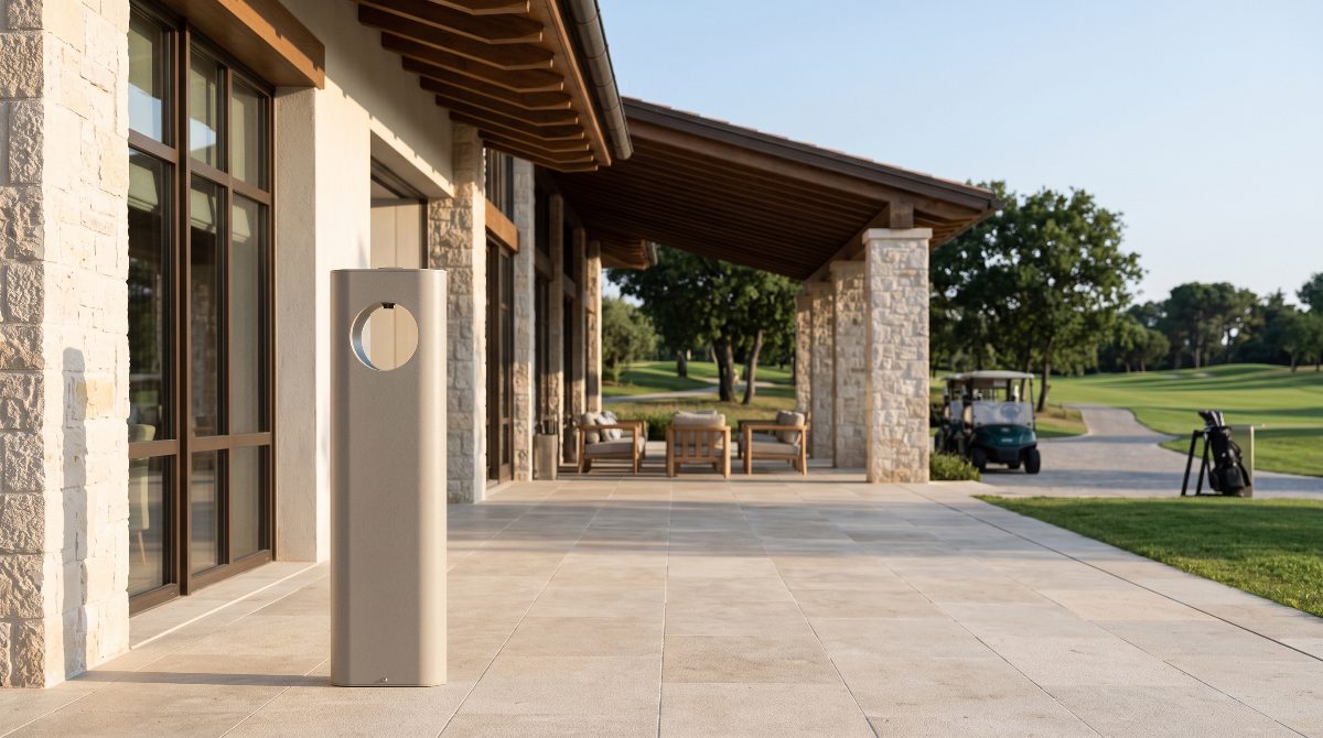 A dispenser outside a golf clubhouse, fairway and buggies beyond the terrace
